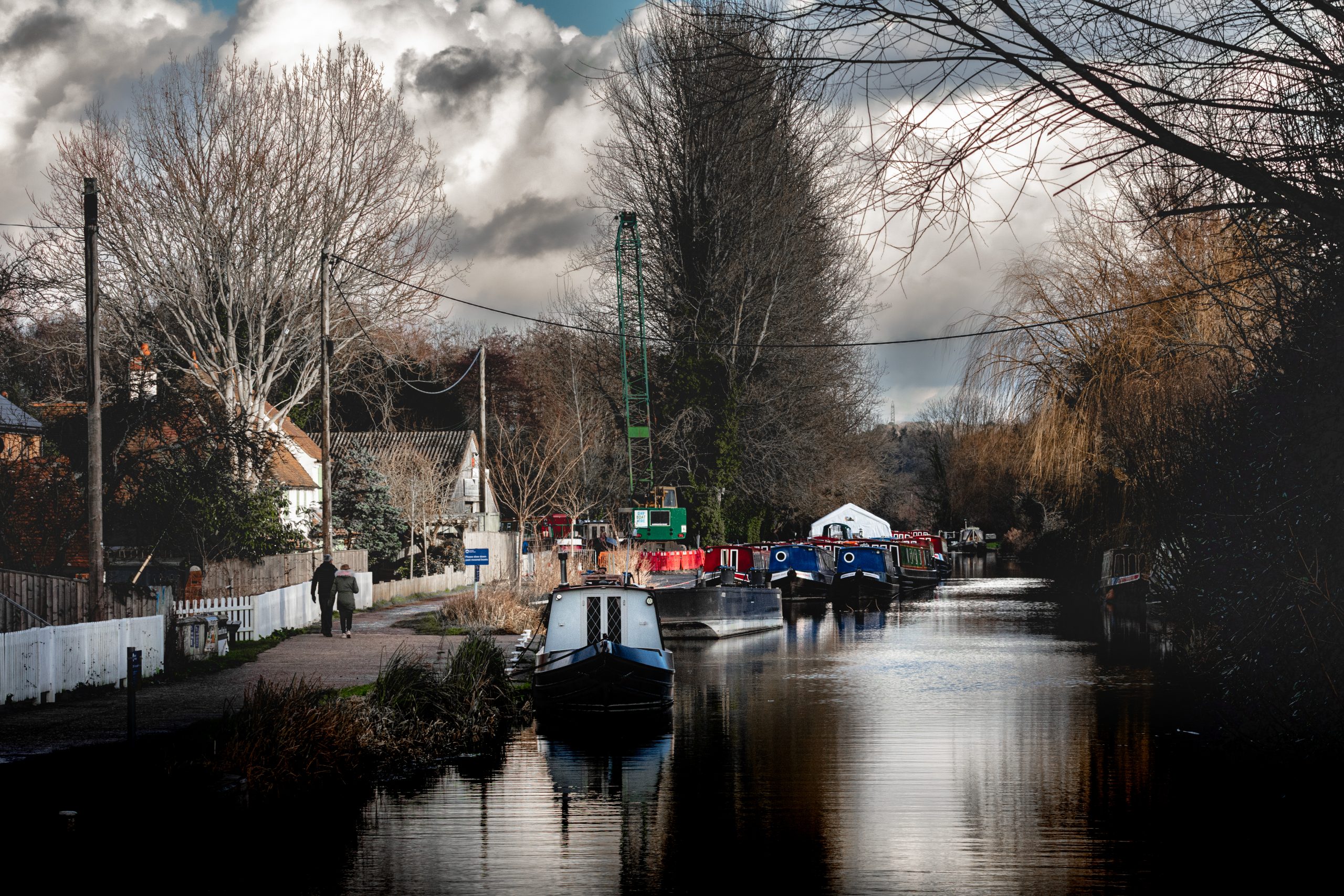 Winter on the Kennet and Avon Canal, cold dark image of a winters day, bare trees and narrow boats.