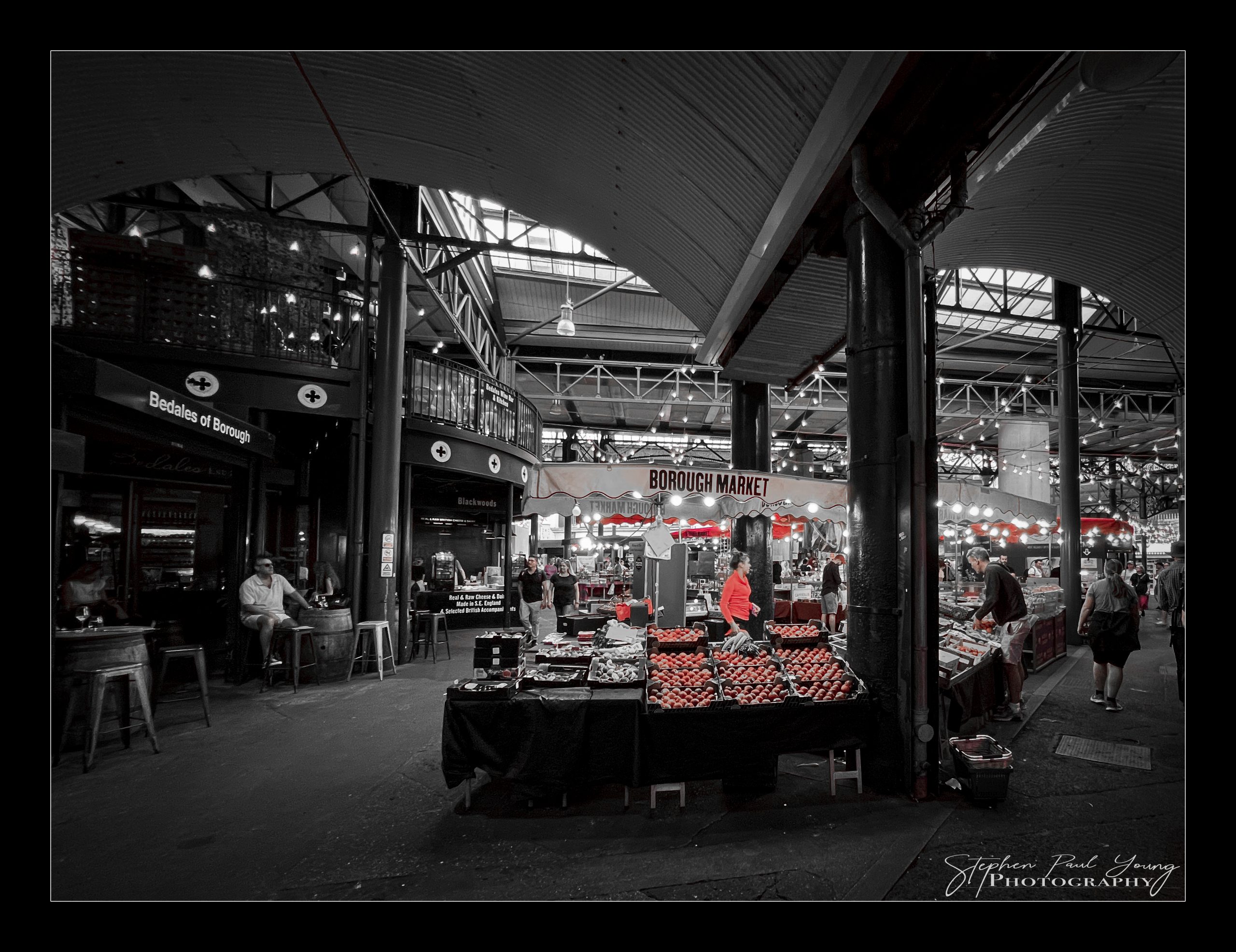 Indulge in 6 Savoury Photographs of Borough Market London: A Photographer's Gastronomic Delight 3 Historic Borough Market in London with arched roof and busy food stalls filled with visitors.