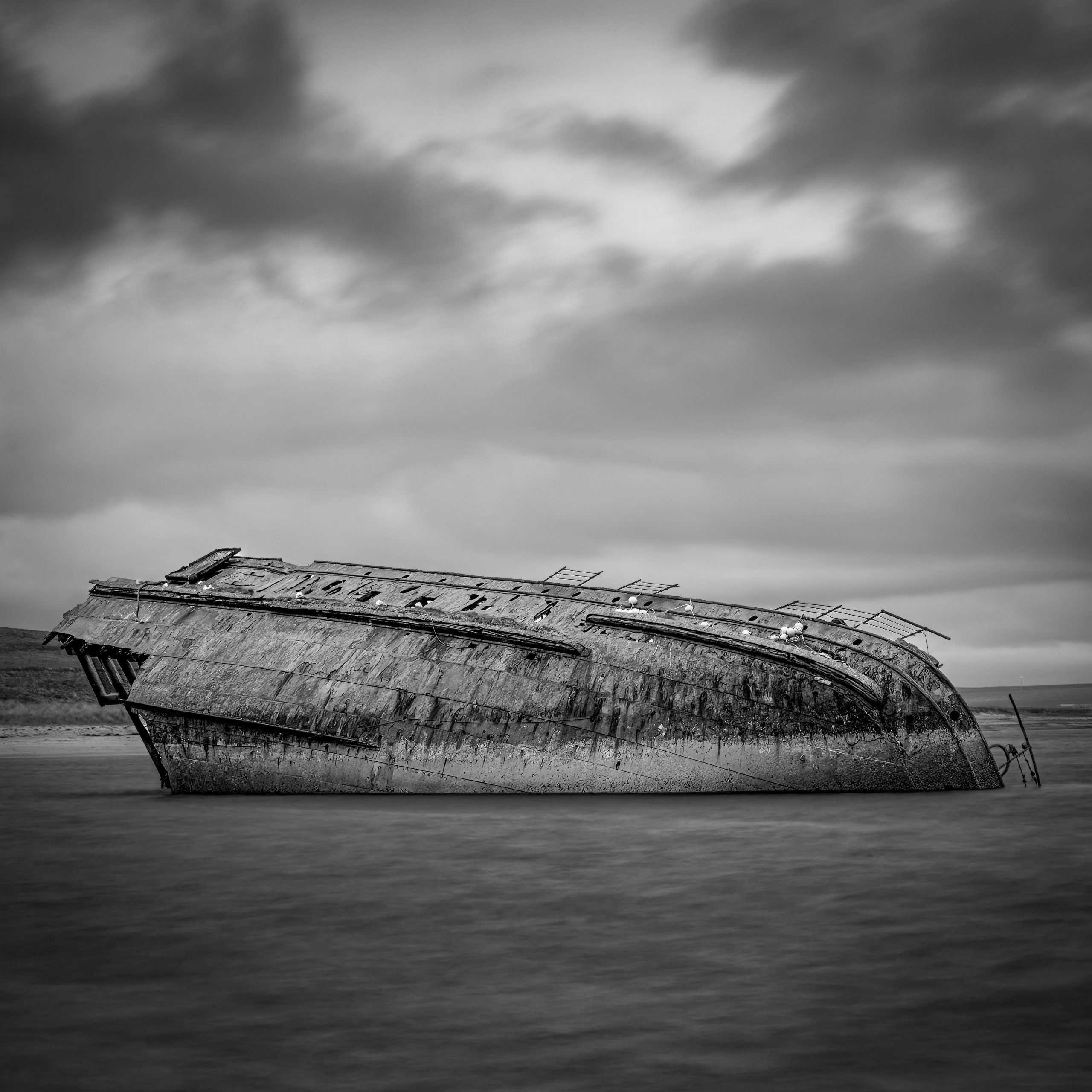 Black and White Photography showing Sunken Ship – The Reginald, Scapa Flow, Orkney, Scotland